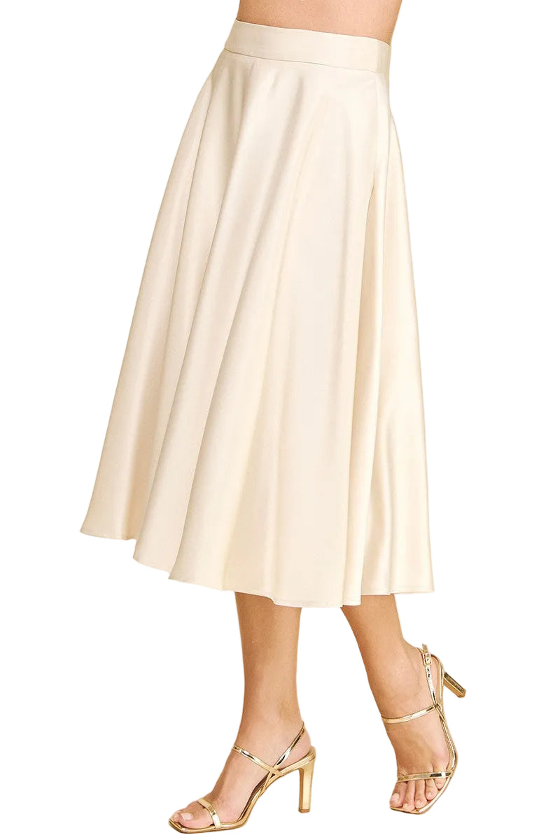 White skirt worn by a person on a beige background