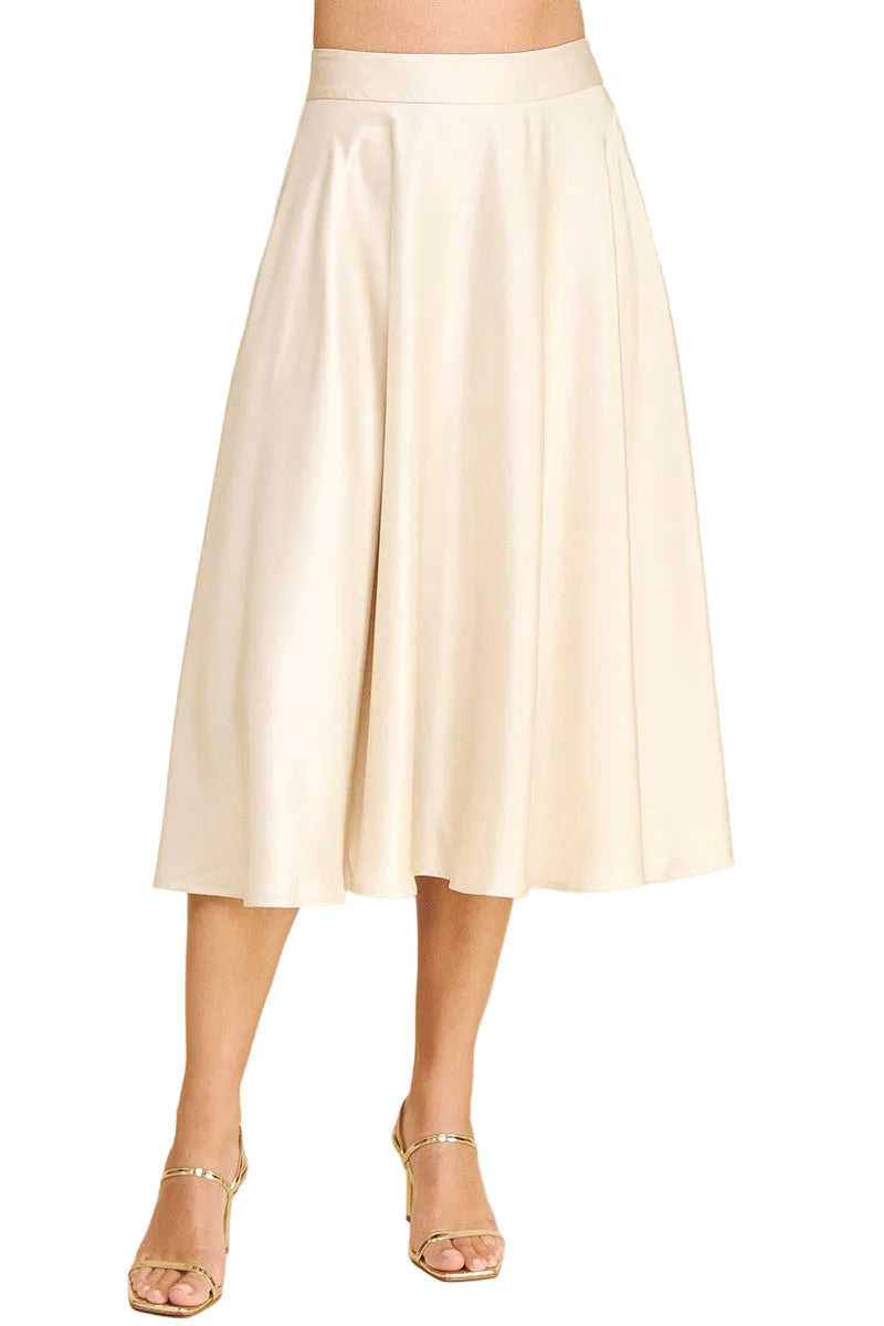 White skirt worn by a person on a beige background